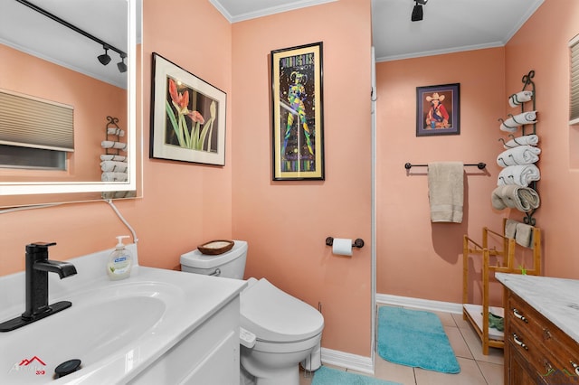 589 County Road 183, Carthage, TX 75633 - full bathroom featuring vanity, toilet, track lighting, tile patterned floors, and baseboards