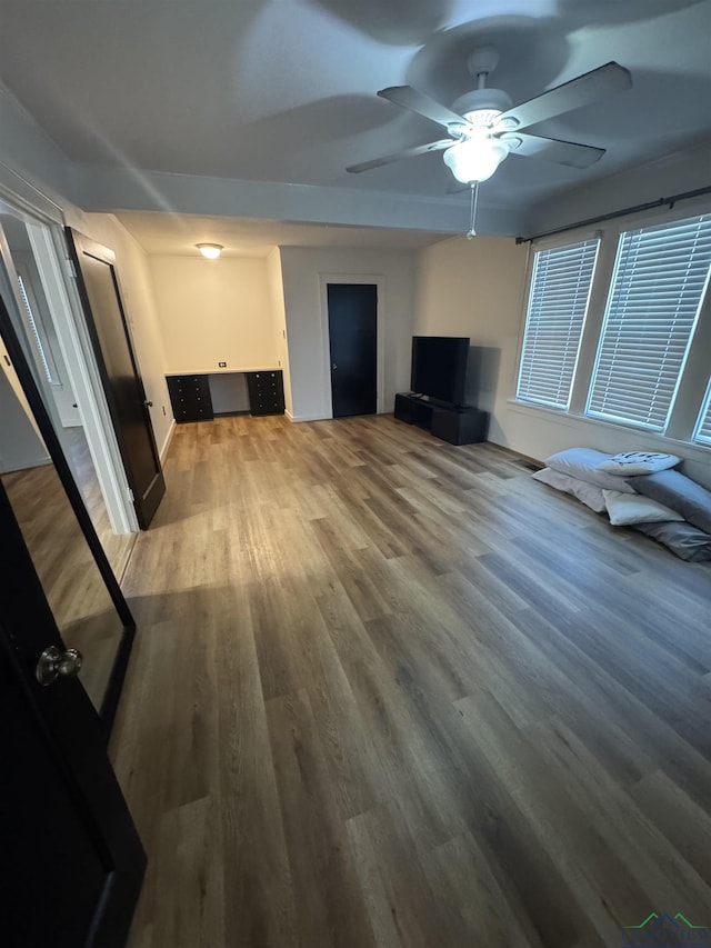 unfurnished living room with ceiling fan and hardwood / wood-style flooring