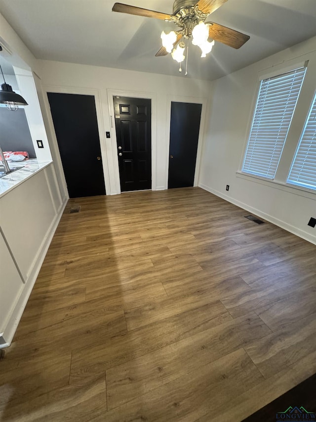 interior space featuring ceiling fan and wood-type flooring