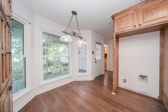 unfurnished dining area with dark hardwood / wood-style floors