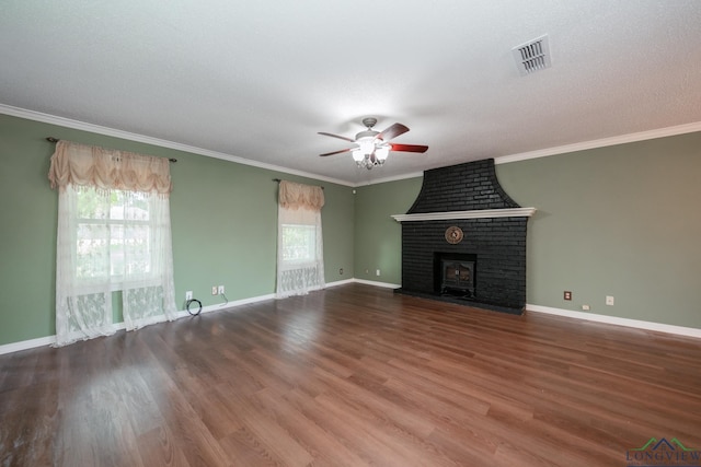 unfurnished living room featuring a fireplace, wood-type flooring, ceiling fan, and ornamental molding