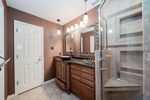 bathroom with tile patterned flooring, vanity, and an enclosed shower