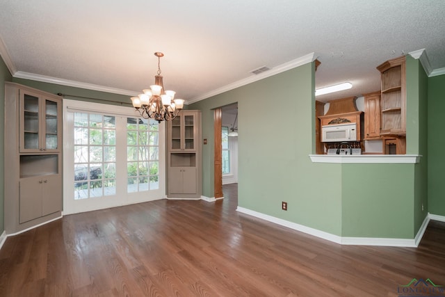 unfurnished dining area featuring a chandelier, wood-type flooring, and crown molding