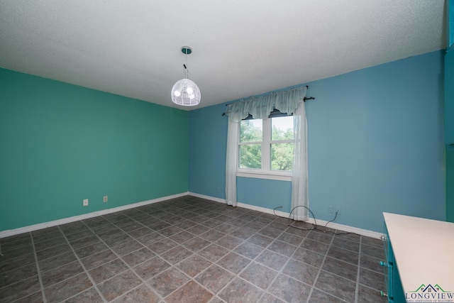 unfurnished room featuring a textured ceiling