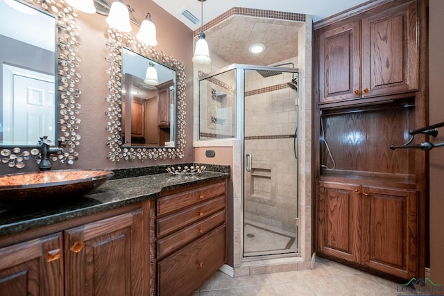 bathroom featuring vanity, tile patterned floors, and an enclosed shower