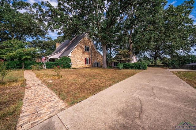 view of home's exterior featuring a lawn and cooling unit