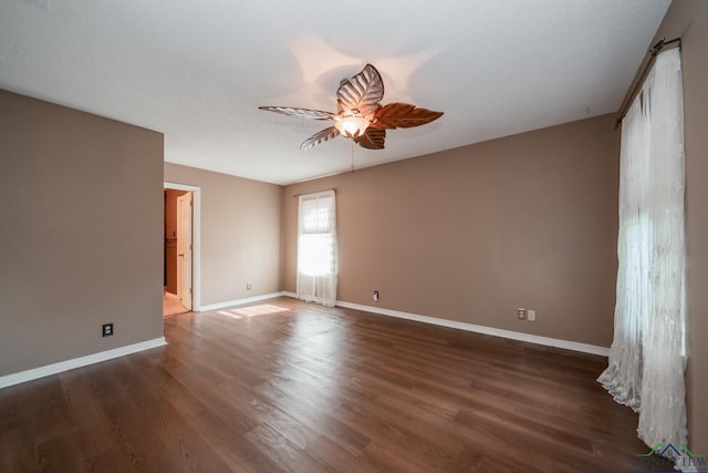 unfurnished room featuring ceiling fan, dark hardwood / wood-style flooring, and a textured ceiling