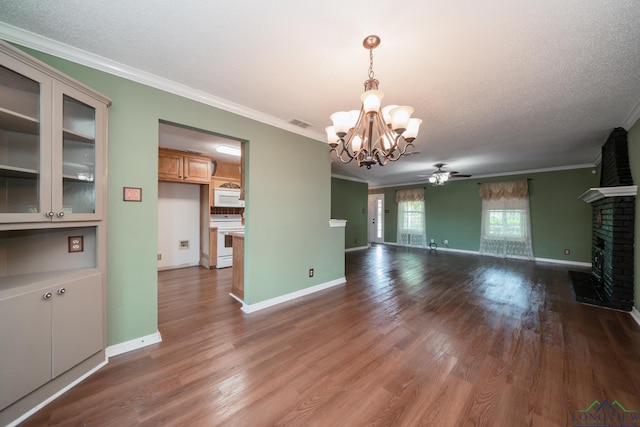 unfurnished living room with crown molding, a fireplace, wood-type flooring, and ceiling fan with notable chandelier