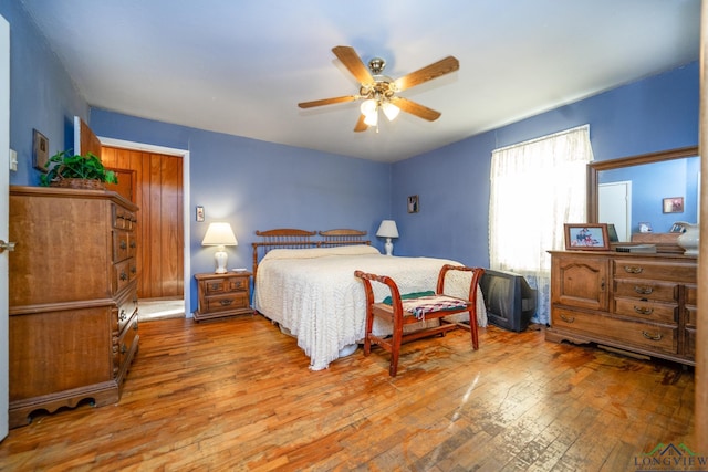 bedroom with ceiling fan and light hardwood / wood-style floors