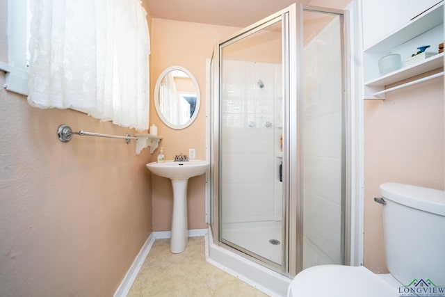 bathroom with toilet and an enclosed shower