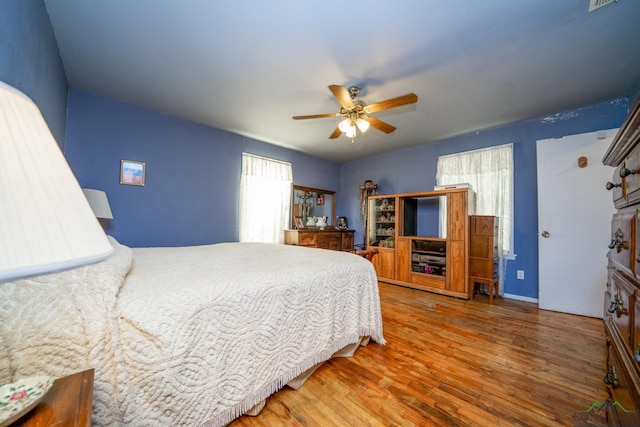 bedroom with hardwood / wood-style flooring and ceiling fan