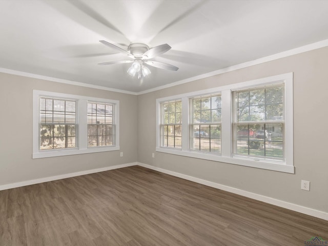 empty room with ceiling fan, dark wood-type flooring, and ornamental molding