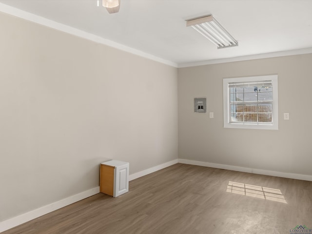 spare room with hardwood / wood-style floors, ceiling fan, and crown molding