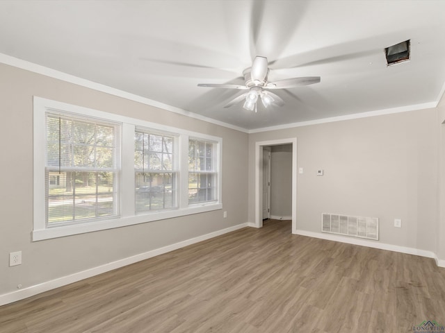 unfurnished room with ceiling fan, light hardwood / wood-style floors, and ornamental molding