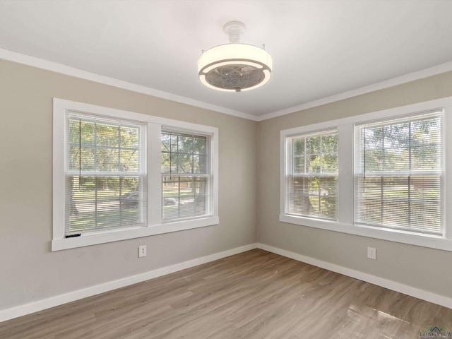 spare room with hardwood / wood-style flooring and ornamental molding