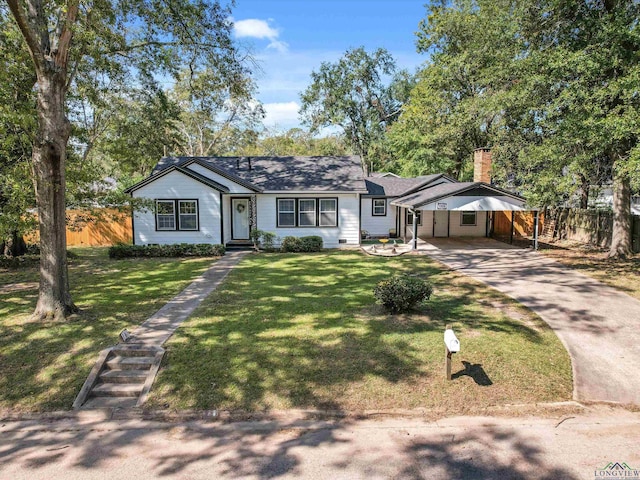 ranch-style house featuring a carport and a front lawn