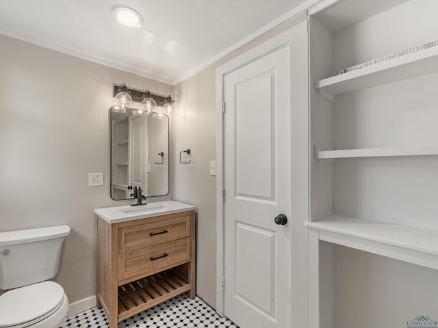 bathroom with vanity, toilet, and ornamental molding