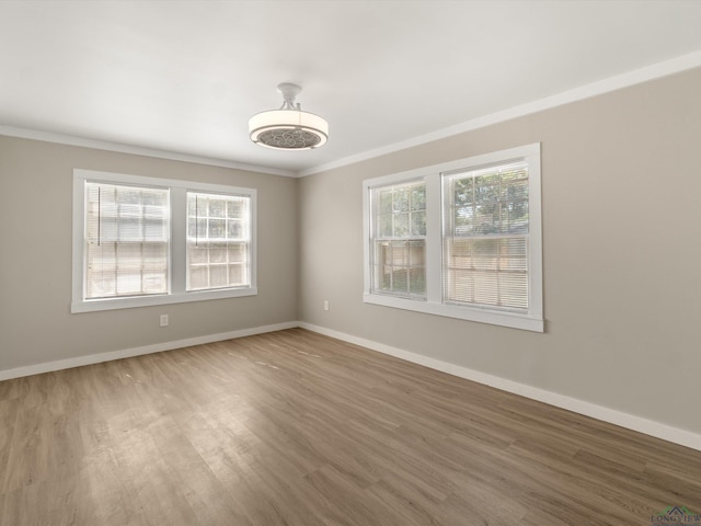 spare room with hardwood / wood-style flooring and ornamental molding