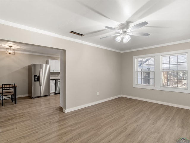 empty room featuring ceiling fan, ornamental molding, and light wood-type flooring