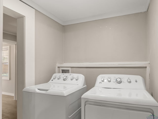 laundry room with crown molding and washer and clothes dryer