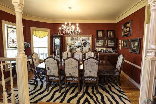 dining room featuring a notable chandelier, ornamental molding, dark wood-type flooring, and decorative columns