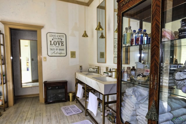 bathroom with backsplash, a fireplace, and hardwood / wood-style flooring