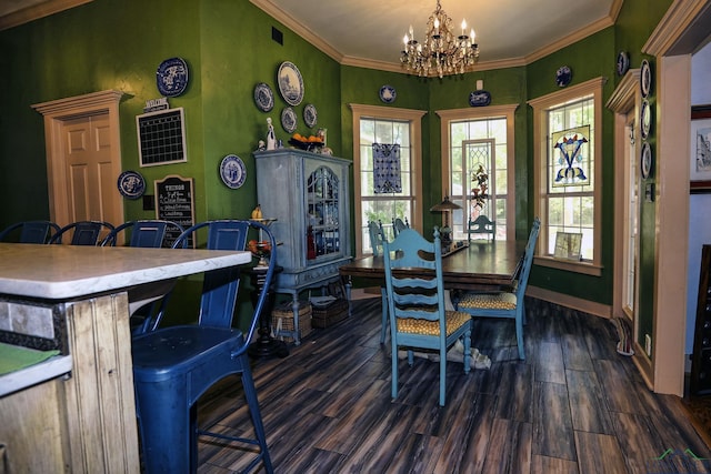 dining area with crown molding, dark wood-type flooring, and a notable chandelier