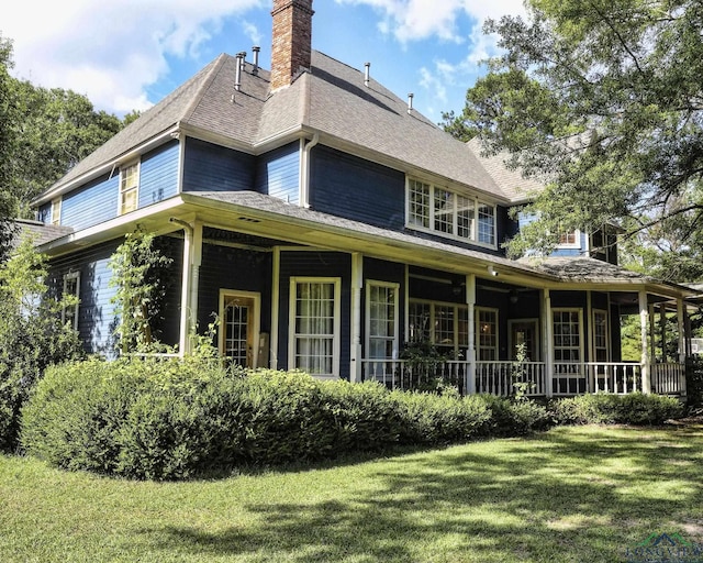 rear view of house with a yard