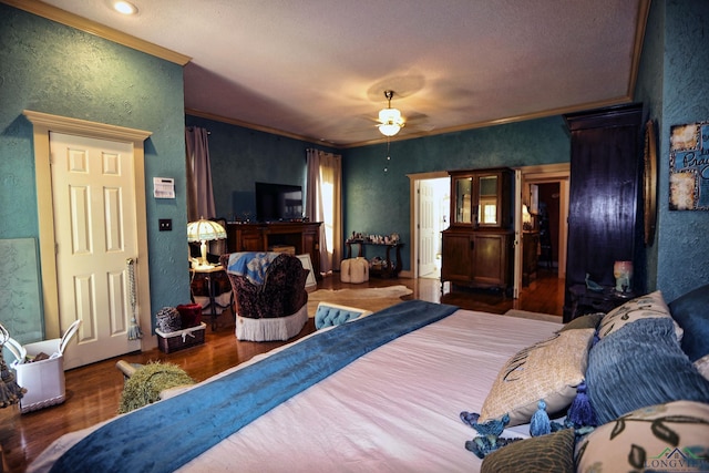 bedroom featuring ceiling fan, ornamental molding, and dark wood-type flooring