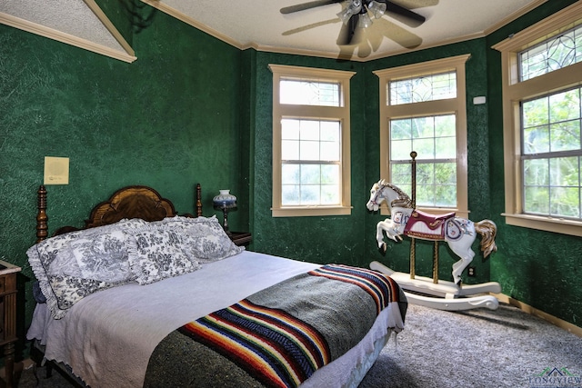 carpeted bedroom featuring ceiling fan, ornamental molding, and multiple windows