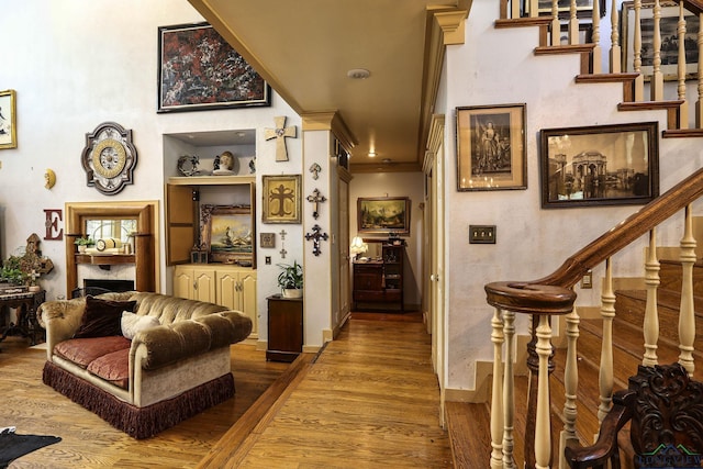 interior space featuring wood-type flooring and ornamental molding