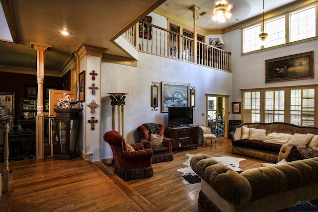 living room with ornate columns, ceiling fan, hardwood / wood-style floors, and ornamental molding