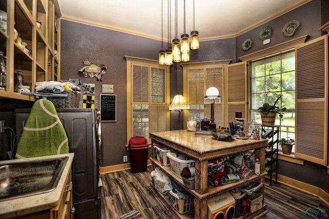 kitchen with a chandelier, crown molding, hanging light fixtures, and dark wood-type flooring