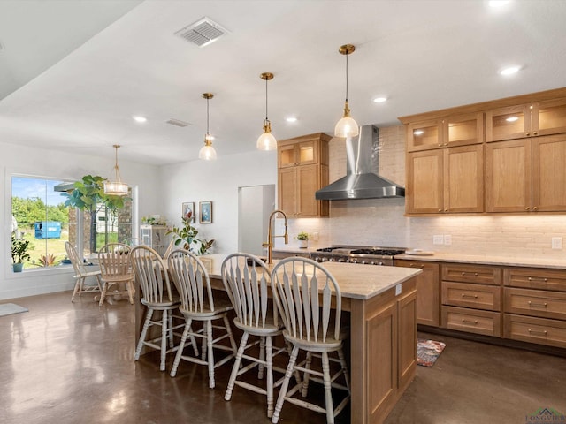 3472 Fm 2869, Hawkins, TX 75765 - kitchen with wall chimney range hood, backsplash, an island with sink, concrete floors, and recessed lighting