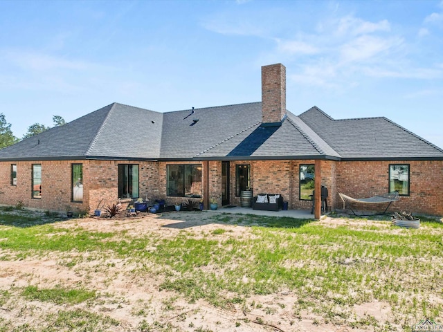 3472 Fm 2869, Hawkins, TX 75765 - rear view of property with brick siding, a chimney, and a patio