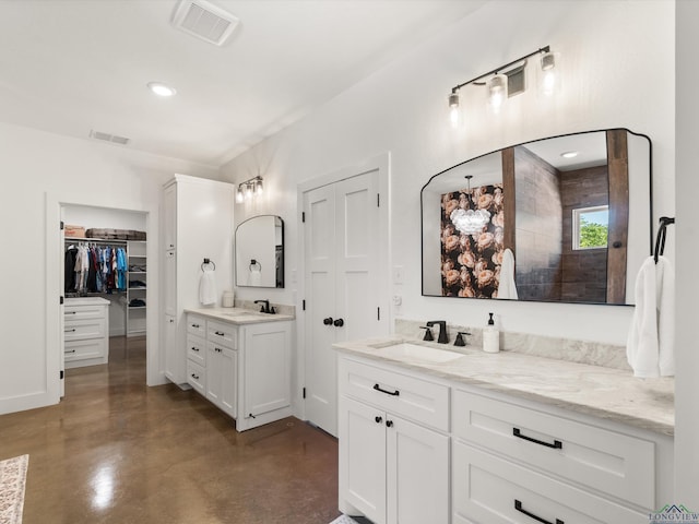 3472 Fm 2869, Hawkins, TX 75765 - bathroom featuring finished concrete flooring, two vanities, a walk in closet, and a walk in shower