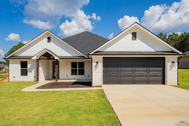 view of front of property featuring a front lawn and a garage