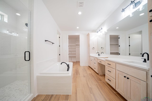 bathroom with vanity and separate shower and tub