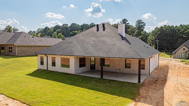 rear view of property featuring a patio area and a yard