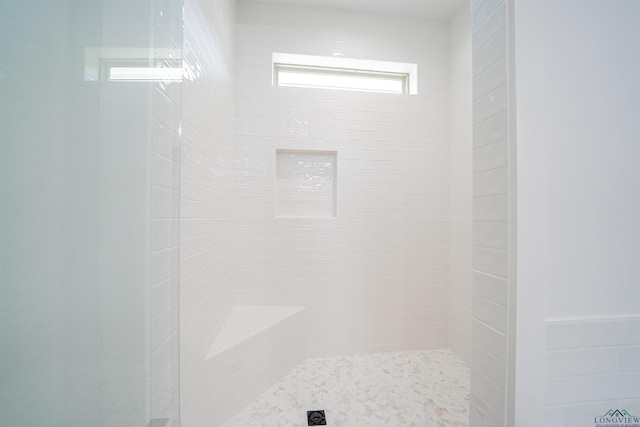 bathroom with a tile shower