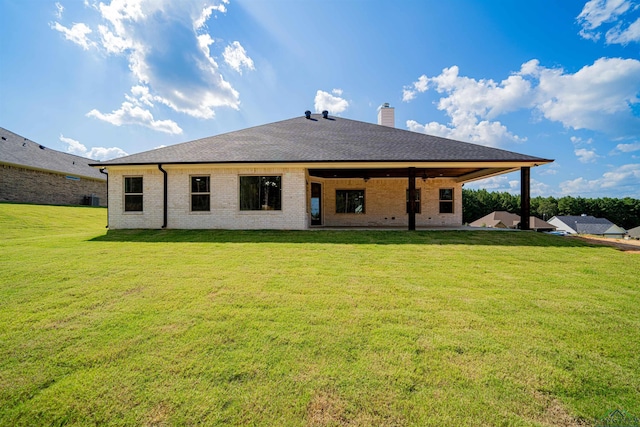 back of property featuring a lawn