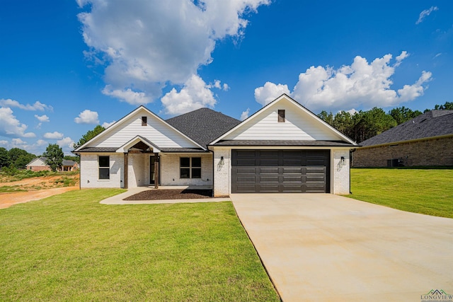 view of front of home featuring a garage and a front yard