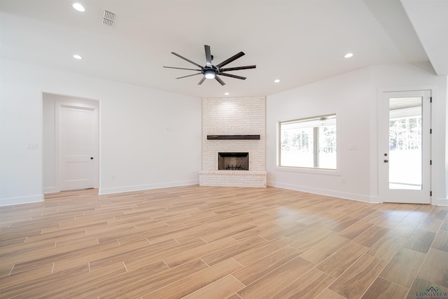 unfurnished living room featuring ceiling fan and a fireplace