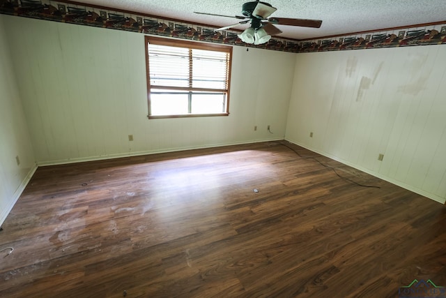 spare room featuring ceiling fan, a textured ceiling, and dark wood-type flooring