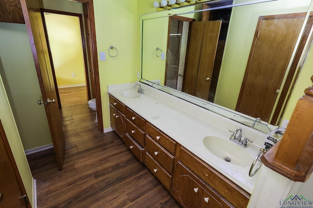 bathroom featuring hardwood / wood-style floors, vanity, and toilet