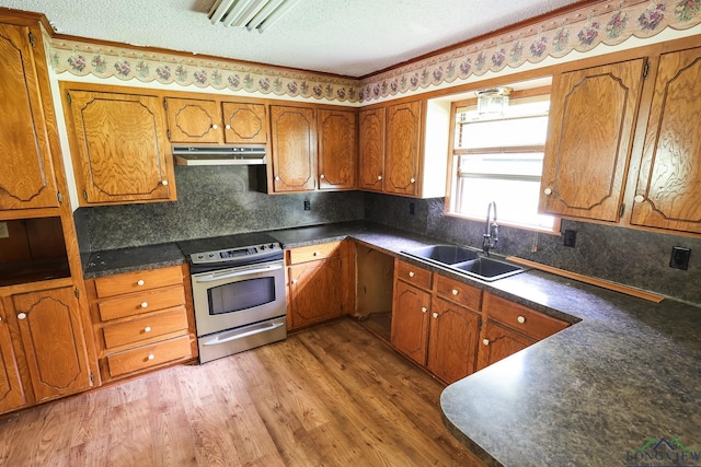 kitchen featuring a textured ceiling, dark hardwood / wood-style floors, sink, and stainless steel range with electric cooktop