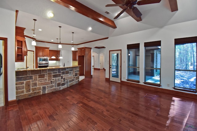 unfurnished living room featuring ceiling fan, lofted ceiling with beams, dark hardwood / wood-style flooring, and a wealth of natural light