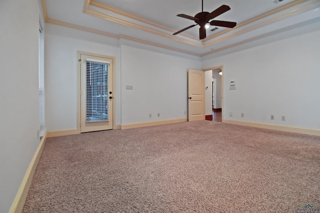 unfurnished room featuring carpet flooring, a tray ceiling, and crown molding