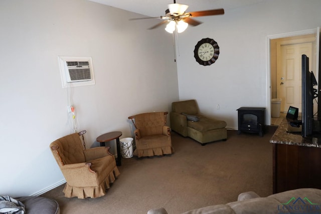 living room with a wall unit AC, ceiling fan, and dark carpet