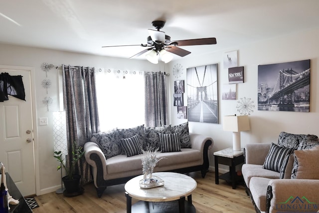 living room featuring light hardwood / wood-style floors and ceiling fan